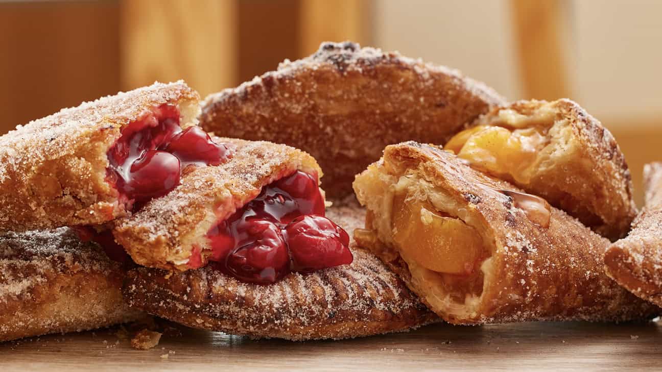 Cherry and apple pies cut in half ready to eat.